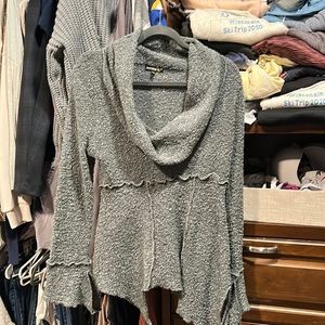 Asymmetrical sweater with bell cuffs.  Size L